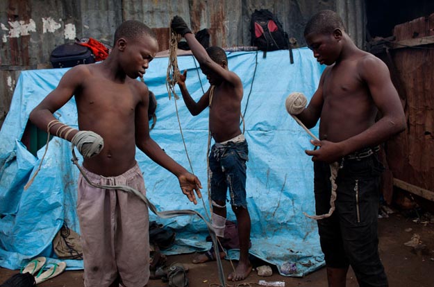 Lagos, Nigeria- Young boxers prepare for their match by tightly